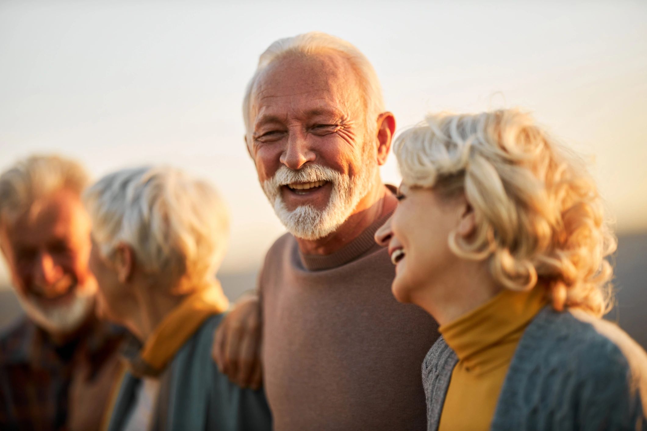 Happy senior man enjoying time outdoors with friends